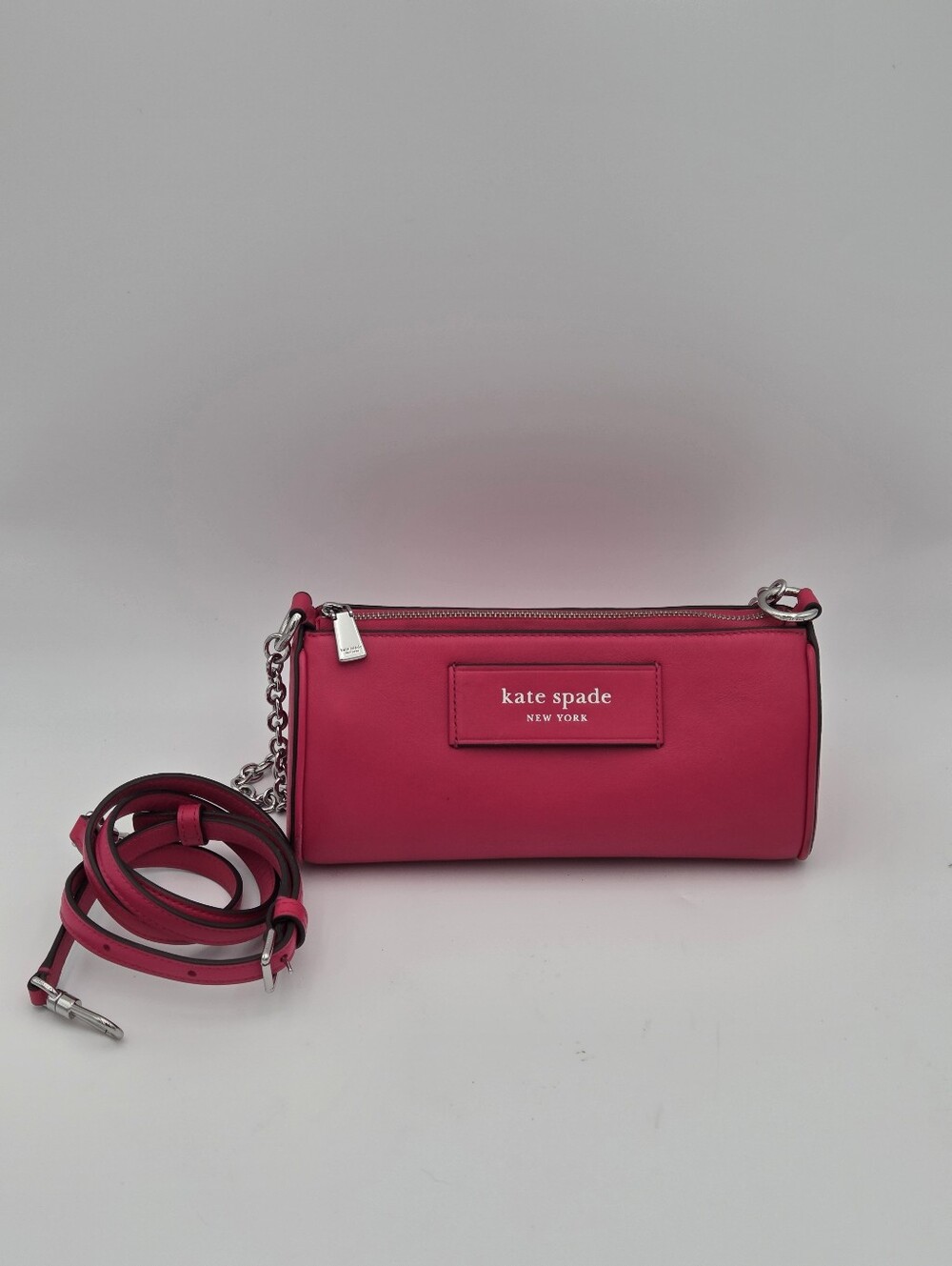 Kate Spade New York label convertible pochette in rosehip pink leather.